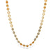 A moonstone chain necklace with varying hues of orange, cream, and gray, stones strung on an 18k yellow gold chain.