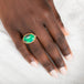 A gold and silver ring featuring an oval gem silica stone on a person's finger