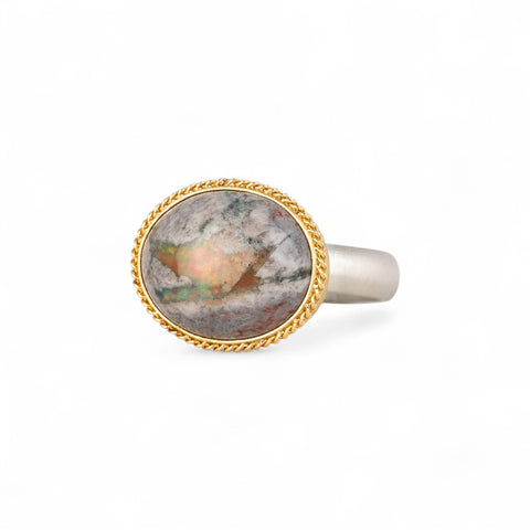Handmade ring with a mexican opal stone, gold setting and sterling silver band