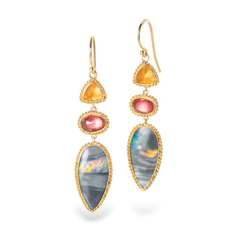 Gold earrings with mixed gemstones on a white background