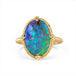 Gold ring with a colorful boulder opal stone on a white background