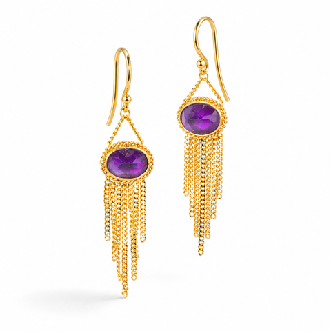 Gold earrings featuring vivid purple amethyst gemstones, shown against a white background.