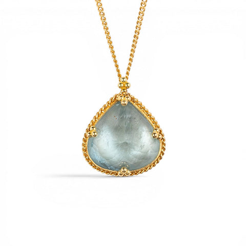 A gold necklace with a teardrop-shaped light blue aquamarine gemstone pendant, set in a textured gold bezel on a white background.