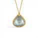 A gold necklace with a teardrop-shaped light blue aquamarine gemstone pendant, set in a textured gold bezel on a white background.