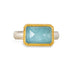Handmade ring featuring an aquamarine gemstone set in an 18k gold bezel and paired with a sterling silver band, against a white background.