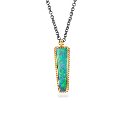 Handcrafted necklace featuring an Australian opal doublet stone set in a gold bezel and paired with an oxidized silver chain, against a white background.