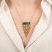 Australian opal doublet necklace with a gold fringe tassel on a person