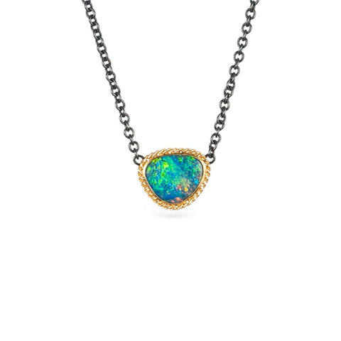 Gold and oxidized silver necklace with an Australian opal doublet on a white background