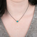 Gold and oxidized silver necklace with an Australian opal doublet on a person