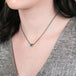 Gold and oxidized silver necklace with an Australian opal doublet on a person