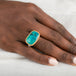 Gold and silver ring with gem silica gemstone on a person's finger