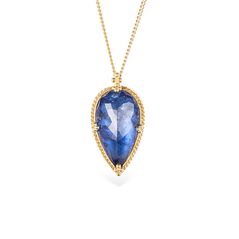 Handmade gold necklace with a blue tanzanite teardrop pendant on a white background