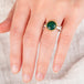 Hand wearing an andamooka opal ring with gold bezel and sterling silver band