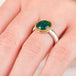 Close up of a hand wearing an andamooka opal ring with gold bezel and sterling silver band