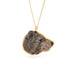 Hand-carved bear head pendant set in an 18k gold bezel, on a gold chain against a white background.