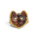 A gold ring featuring a carved dark brown and black cat face with green Tourmaline eyes, set against a clean white background.