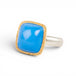 Gold and silver ring with blue ceruleite stone on white background