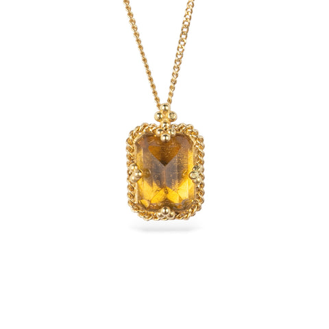 Gold necklace featuring a citrine gemstone, shown against a white background.