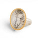 Gold and silver ring featuring a dendritic quartz stone on a white background