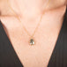 Necklace with a teardrop-shaped diamond set in a handcrafted gold bezel on a person