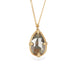 Necklace with a teardrop-shaped diamond set in a handcrafted gold bezel on a white background