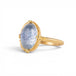 Gold ring with a blue dumortierite stone on a white background