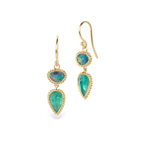 Gold earrings with emerald and australian opal gemstones on a white background