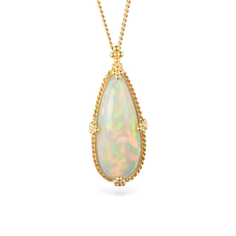 Gold necklace featuring an Ethiopian opal gemstone set in a handcrafted 18k gold bezel and strung from a matching gold chain, against a white background.