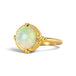 Gold ring featuring a circular Ethiopian opal gemstone set in a handmade 18k gold bezel, against a white background.