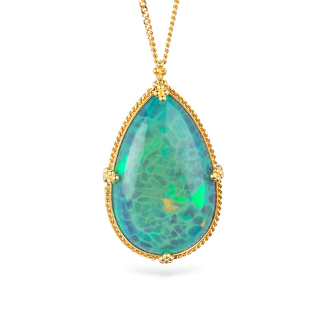 Handcrafted gold necklace featuring a large, teardrop-shaped Ethiopian opal gemstone set in an 18k gold bezel with a matching gold chain, set against a white background.