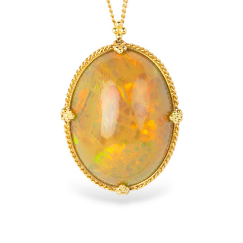 Ethiopian opal pendant with gold frame on a white background