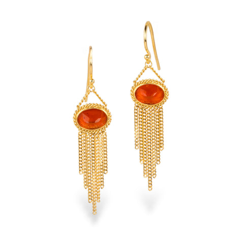 A pair of gold drop earrings featuring oval fire opal gemstones in a textured bezel setting, with gold chain fringe hanging below, shown on a clean white background.
