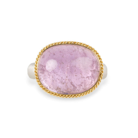 A gold and silver ring featuring a pink kunzite stone, shown against a white background