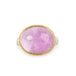 An oval kunzite ring with a gold bezel and sterling silver band, against a white background