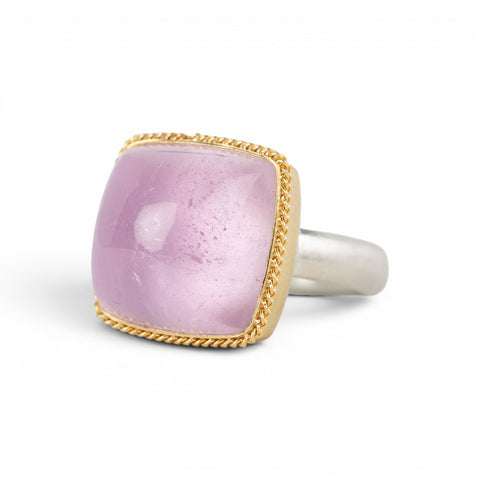 A square cushion-cut kunzite gemstone ring with a gold bezel and a sterling silver band, shown on a plain white background.