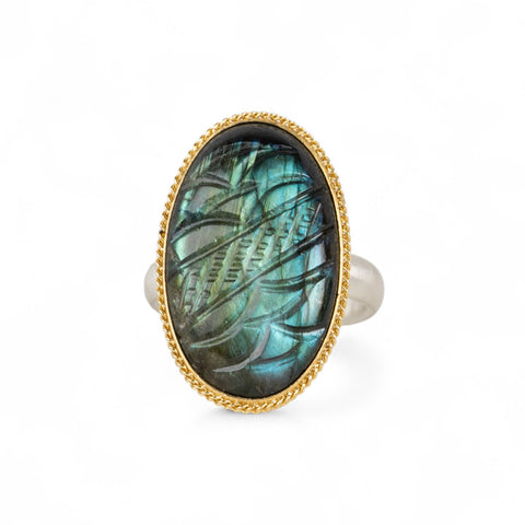 Handmade fine jewelry labradorite ring with carved design set in 18k gold with a sterling silver band