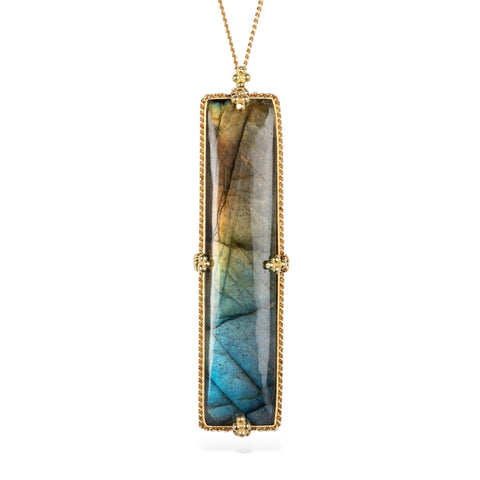 Handmade 18k gold necklace with a rectangular labradorite gemstone on a white background.