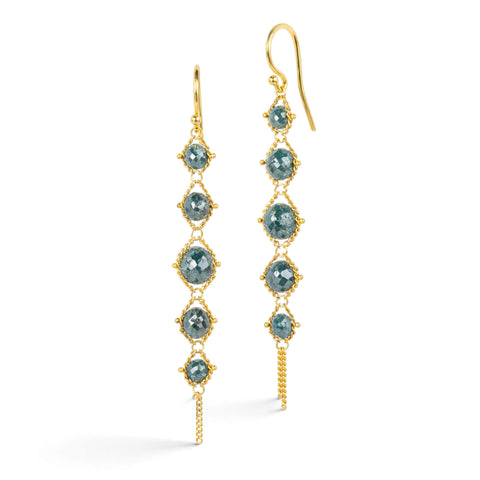 Gold earrings featuring rows of shimmering blue diamonds, shown against a white background.
