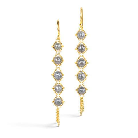 Gold earrings featuring five grey diamonds each, against a white background.