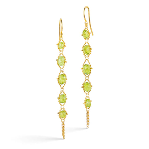 Gold earrings featuring rows of peridot gemstones, shown against a white background.