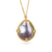Gold necklace featuring a mabe pearl set in a handcrafted 18k gold bezel, against a white backgorund.