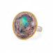 Ring with a mexican opal stone and 18k gold bezel with a sterling silver band on a white background