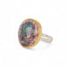 Ring with a mexican opal stone and 18k gold bezel with a sterling silver band on a white background