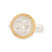 Gold moonstone ring with a moon face design on a white background