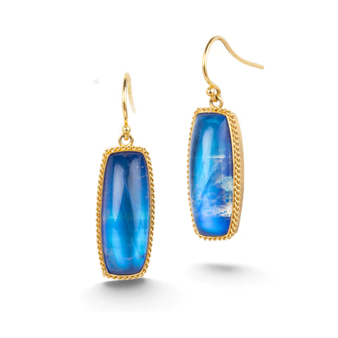 Gold earrings featuring large, blue moonstones, shown against a white backdrop.