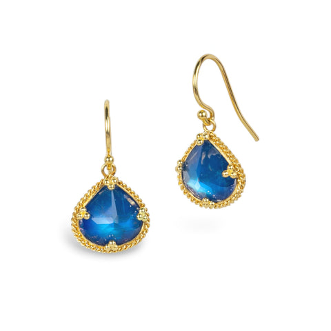 Gold earrings featuring blue moonstone gemstones, shown against a white background.