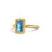 A gold ring featuring a rectangular moonstone set in a 18k gold bezel, against a clean white background.