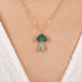 Boulder opal mushroom necklace with gold frame on a person