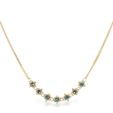 18k yellow gold chain necklace featuring a row of seven blue diamonds in the center.
