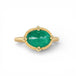 Gold ring with an emerald gemstone on a white background